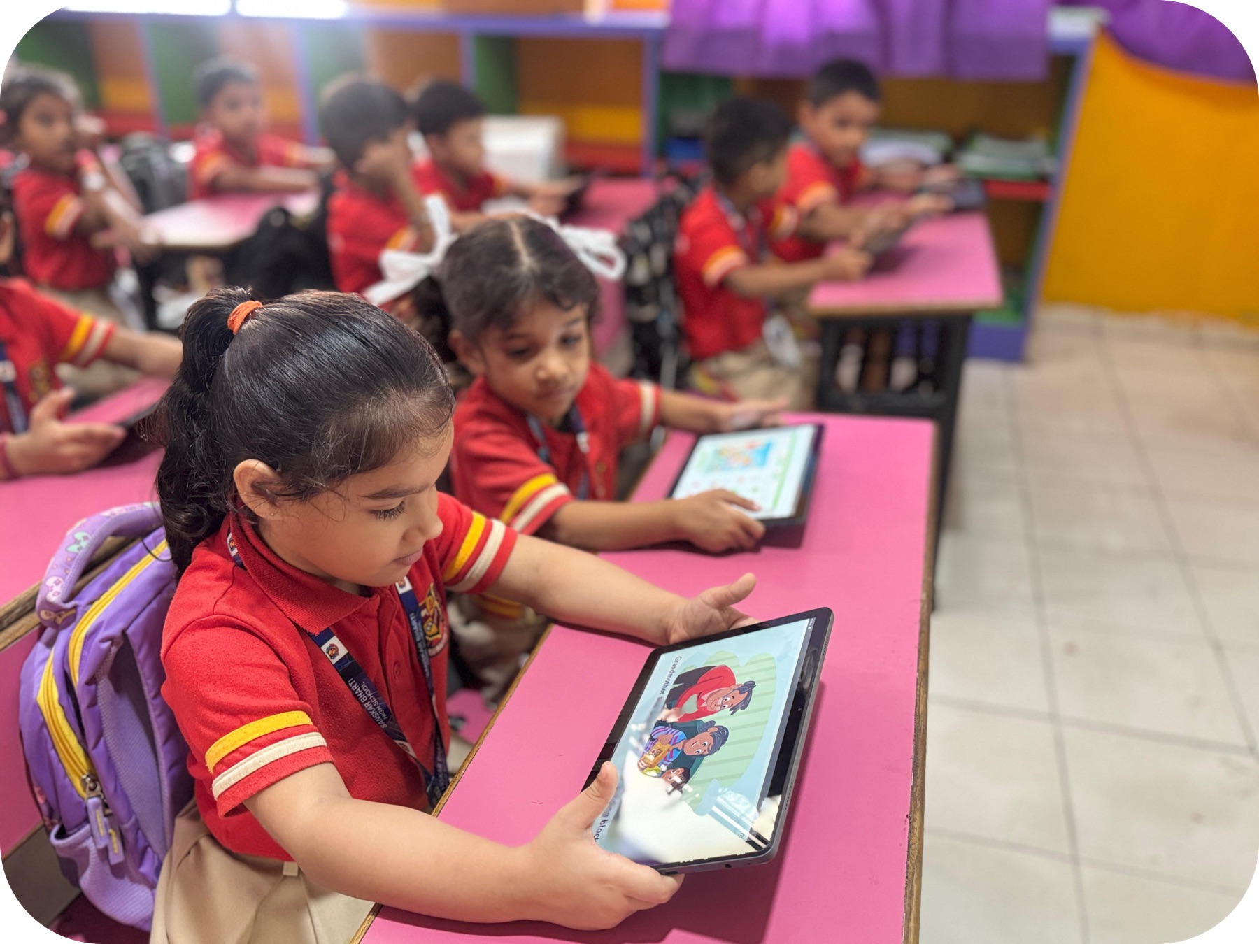 Kindergarten students learning with tablets